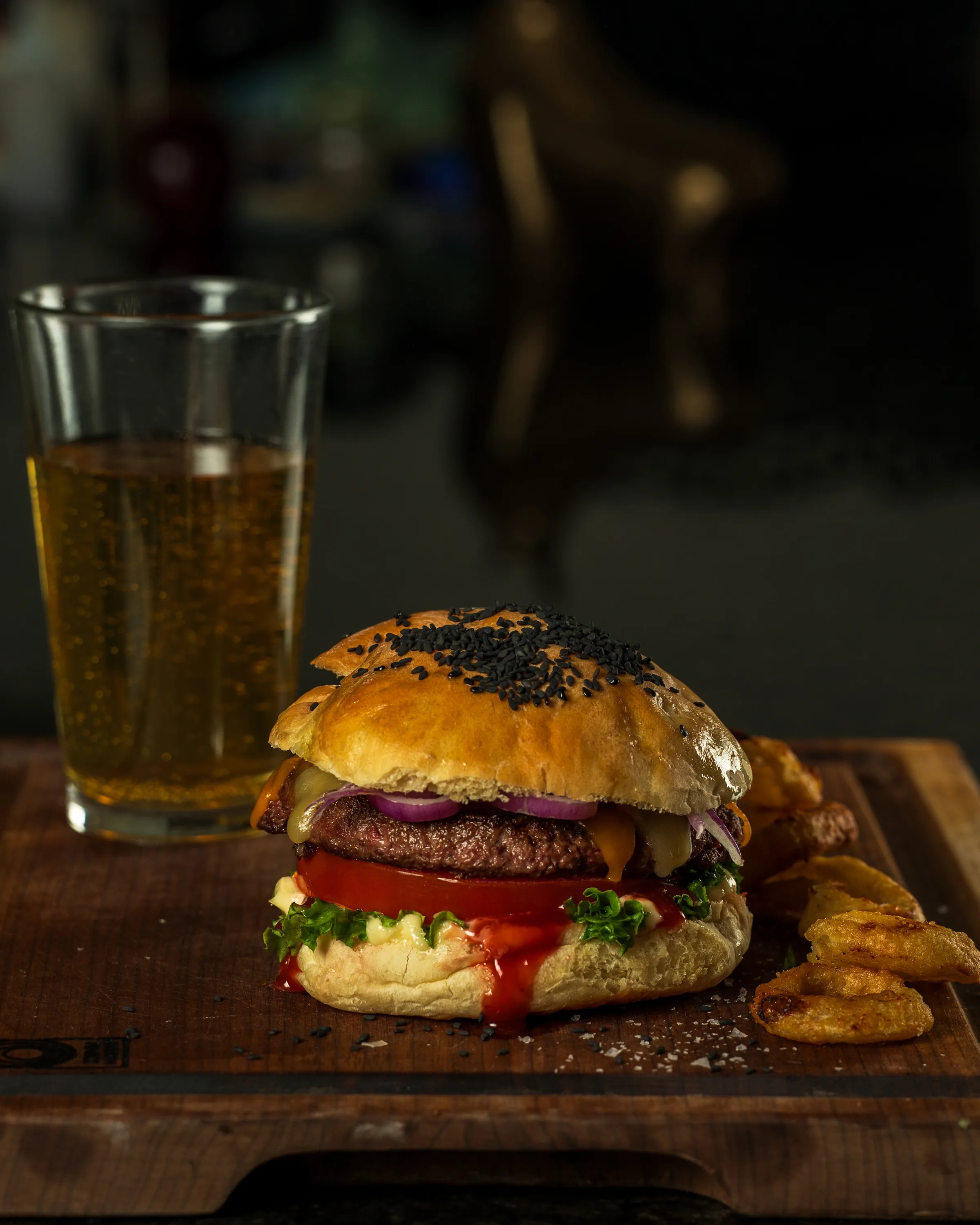 Gourmet burger with onion rings and drink - professional food photography